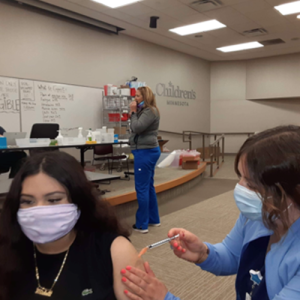 Michelle getting her COVID-19 vaccine shot