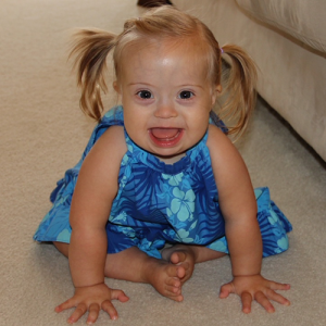 Mary Kate sitting on the floor smiling