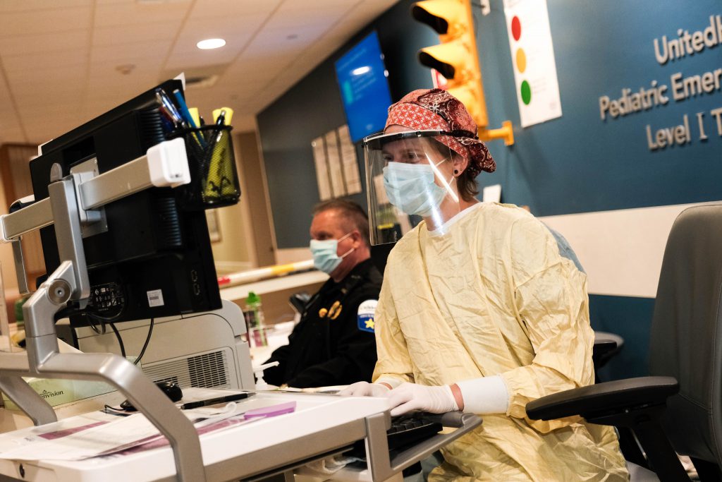 Welcome desk at Children's Minnesota United Healthcare Emergency Department in Minneapolis with a health care provider in personal protective equipment.