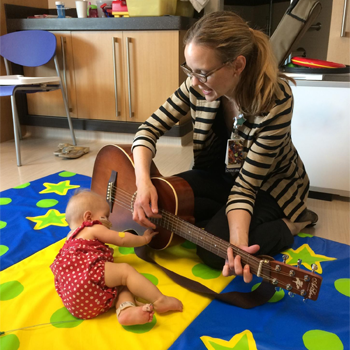 A Children's Minnesota music therapist playing with a little patient