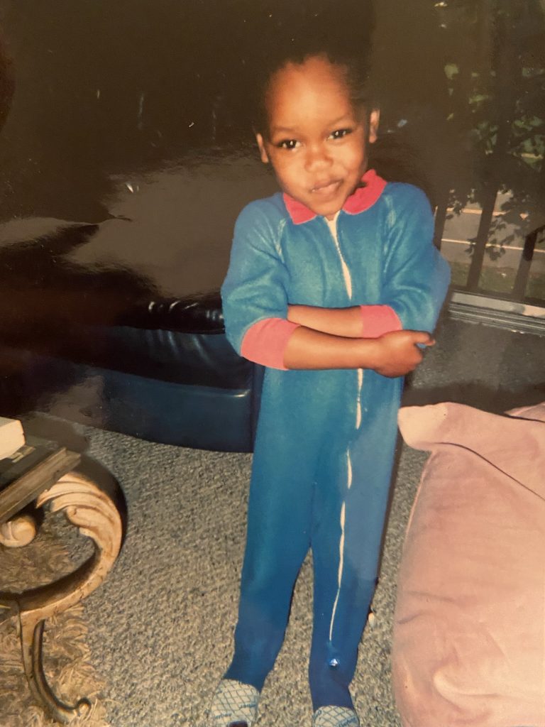 Naz in blue pjs as a child