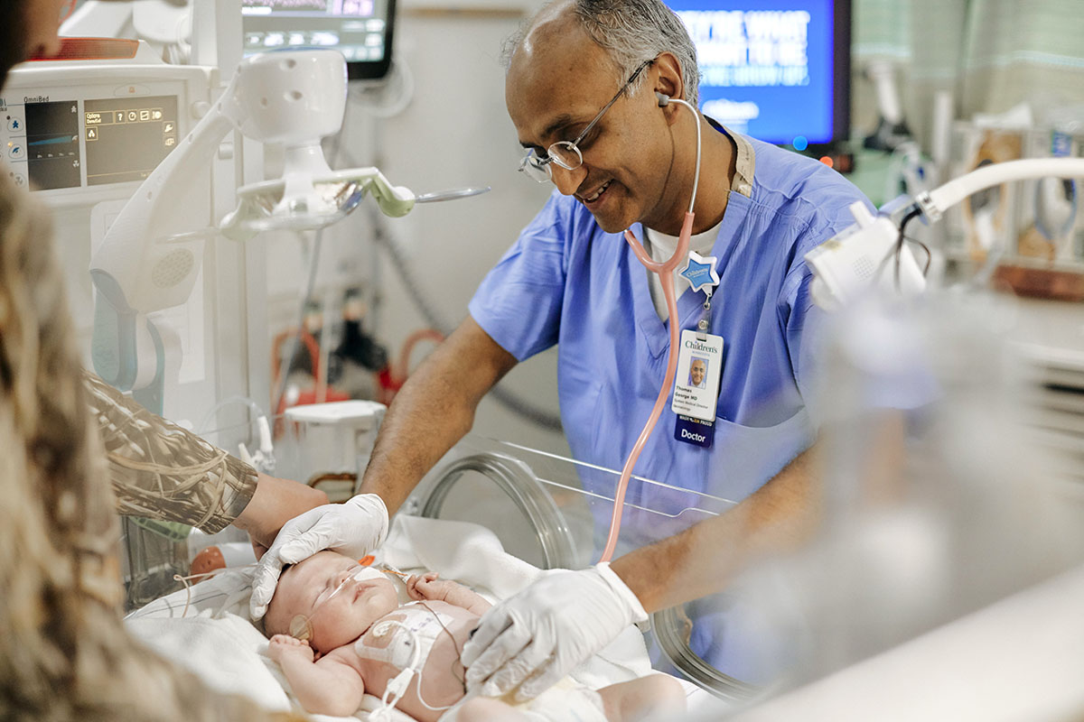 Thomas George, neonatology MD, FAAP monitoring infant in NICU