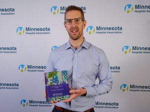Nick Petersen holding the MHA award.