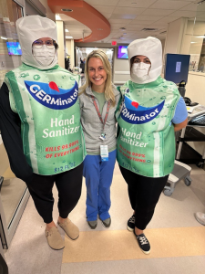 two people dressed in hand sanitizer costumes and one nurse
