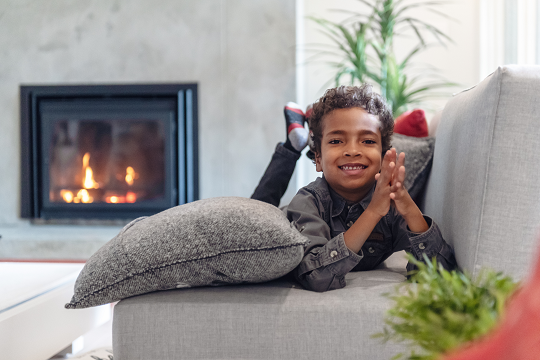Child smiling on couch