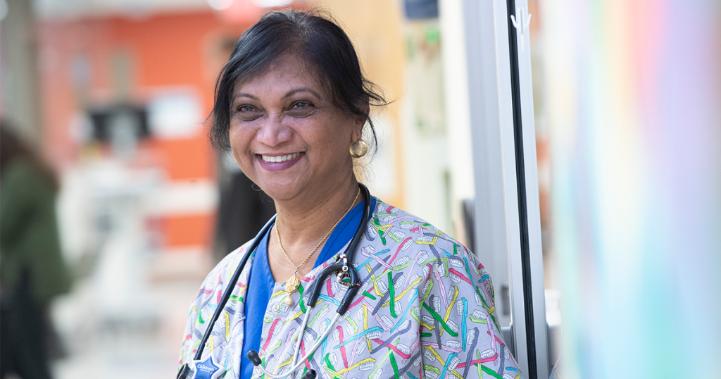 Children's Minnesota nurse smiling in scrubs