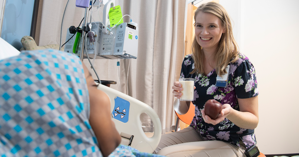 Dietary aide bringing a meal to a Children's Minnesota patient
