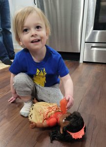 Oliver playing with a toy