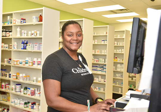 Children's Minnesota pharmacy tech working on a computer in the pharmacy