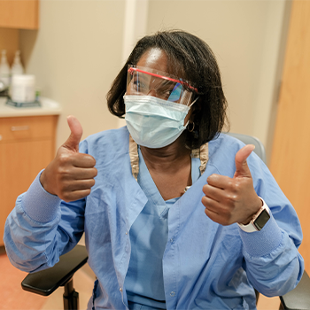 Children's Minnesota employee giving thumbs up