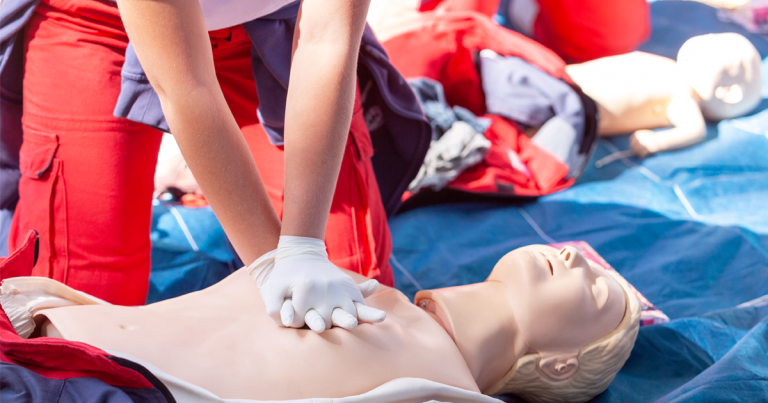 Trainee preforming CPR on a dummy