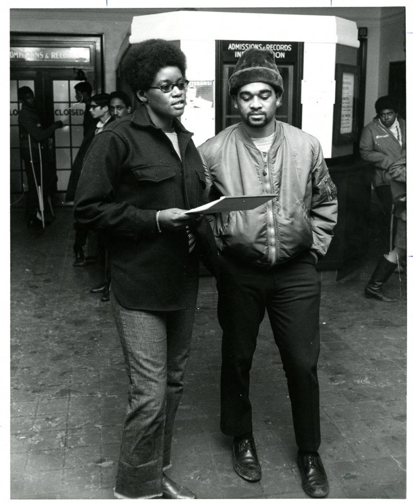 Photo of Rose Mary Freeman and Horace Huntley inside Morrill Hall talking in 1969.