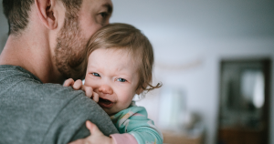 Dad holding sick baby