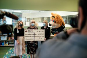Both foundation team holding check