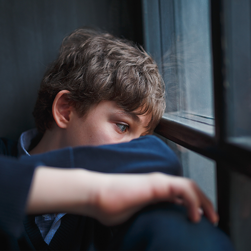 sadteen Sad teen boy staring out the window
