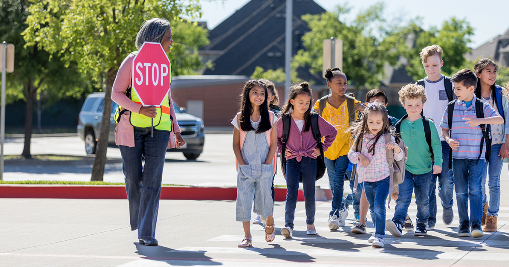 Kids safely crossing the street to school