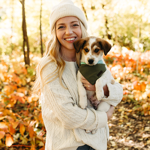 Katherine Nash, PA, hematology oncology, holding her dog outside during the fall