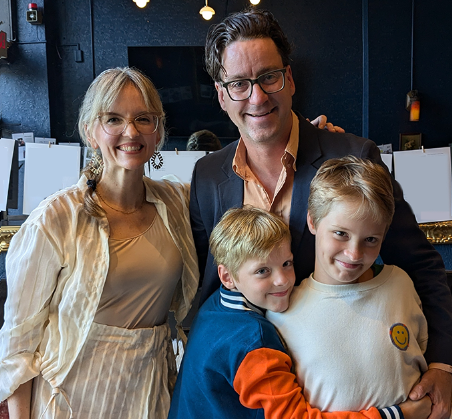 Sarah Woolever, MM, MT-BC, music therapist, with her family at an event
