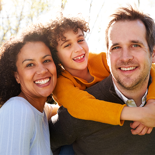 Mixed race family outside in the fall.