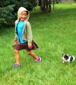 Camber playing outside with her dog
