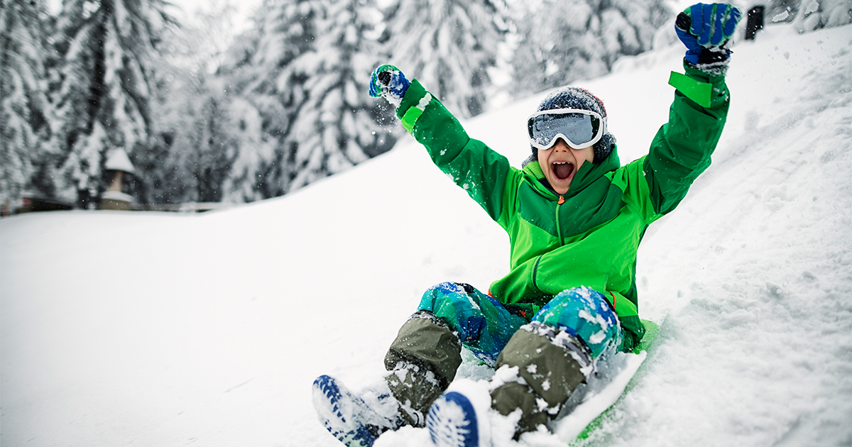 6-year-old-boy in blue helmet sledding