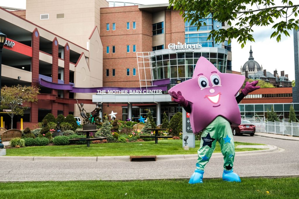 Sparkle the star mascot, stands outside of the St. Paul hospital