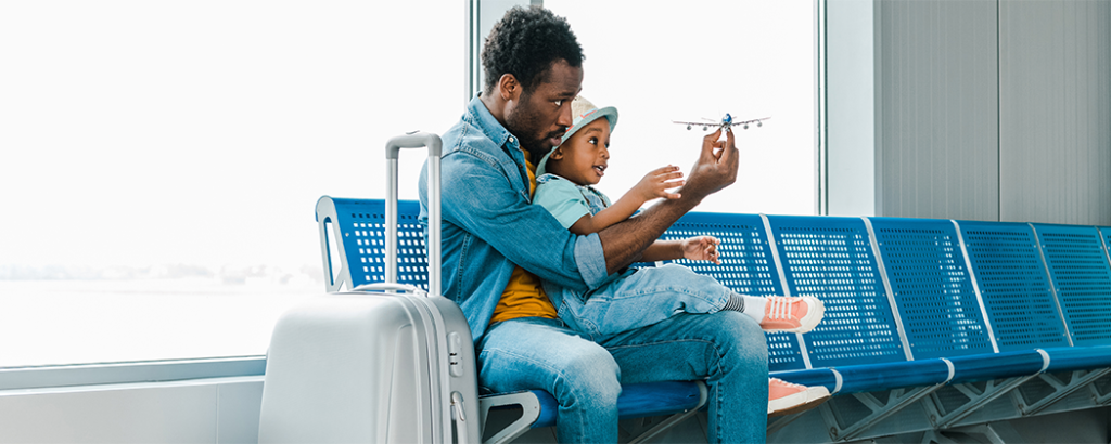 Father and young son at the airport before a spring break trip