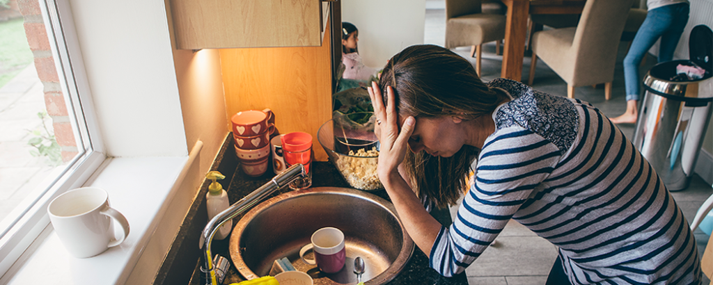 Stressed mom in kitchen that's messy.