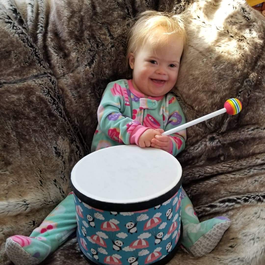 Tallulah at home on the couch with an instrument