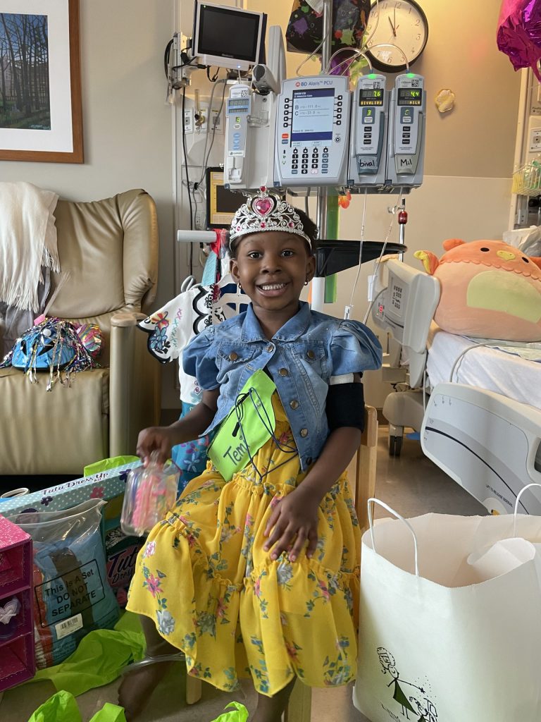 Temi with her gifts granted by Little Wishes.