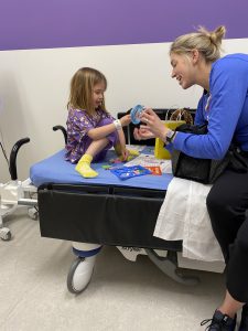 Sydney Weaver and her patient in the hospital playing with toys