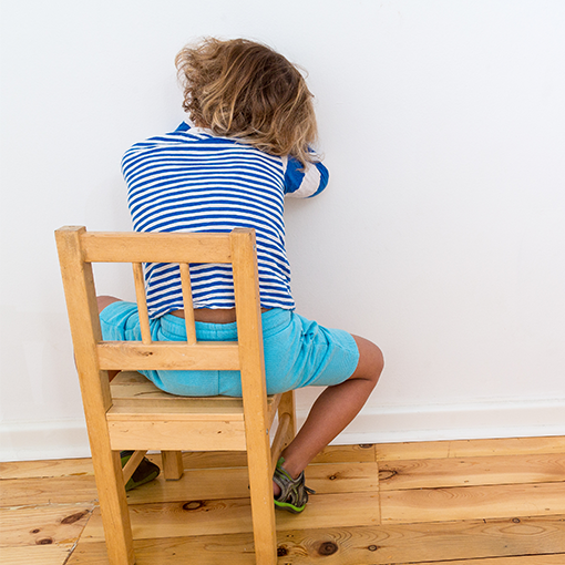Child in a timeout on a chair.