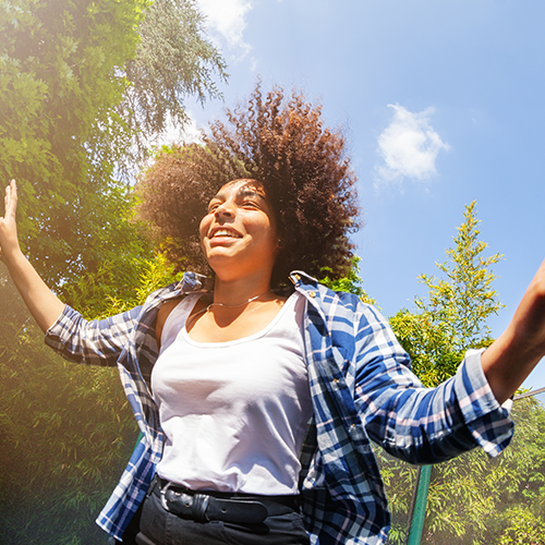 Teenage girl bouncing on the trampoline