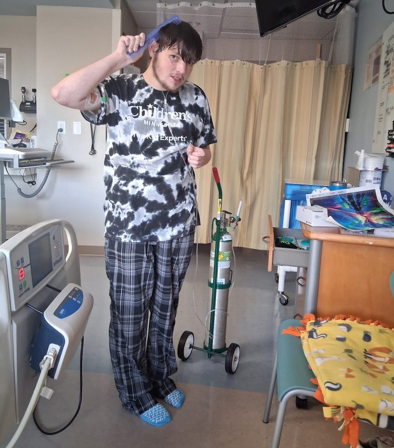 Trever combing his hair during his recent stay at Children's Minnesota for medical concerns.