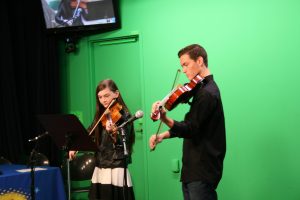 Trinity playing violin on Star Studio
