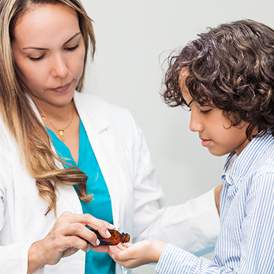 Doctor giving child essential oils