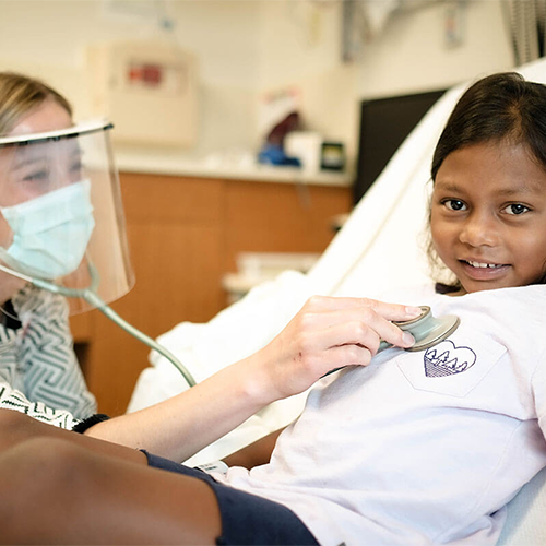 Child with cancer with Children's Minnesota employee.
