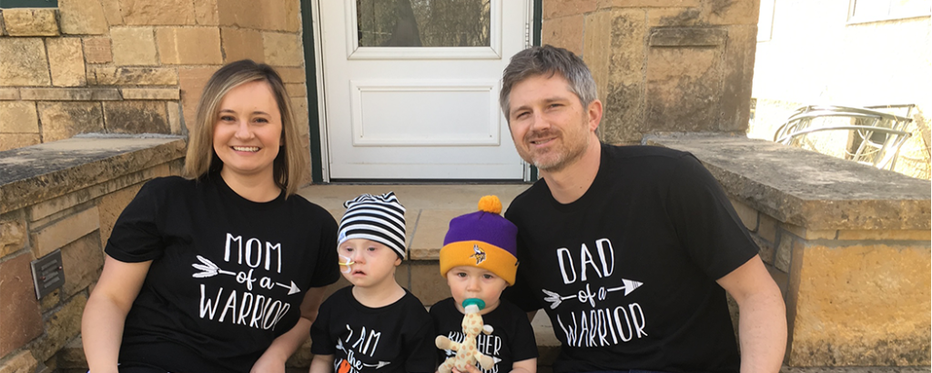 Oliver's family outside their house taking a family photo