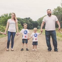 Shelby Herlick's family standing on a dirt road holding hands