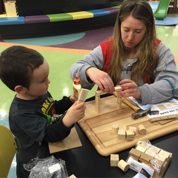 Children's Minnesota volunteer playing with a patient in the hospital