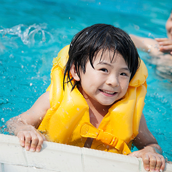 girl swimming with life jacket