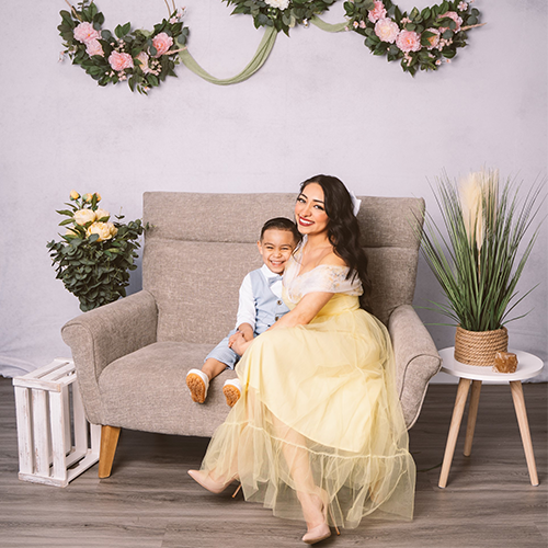 Wendy Zúñiga, pharmacy coordinator, and her son smiling for a professional photo.