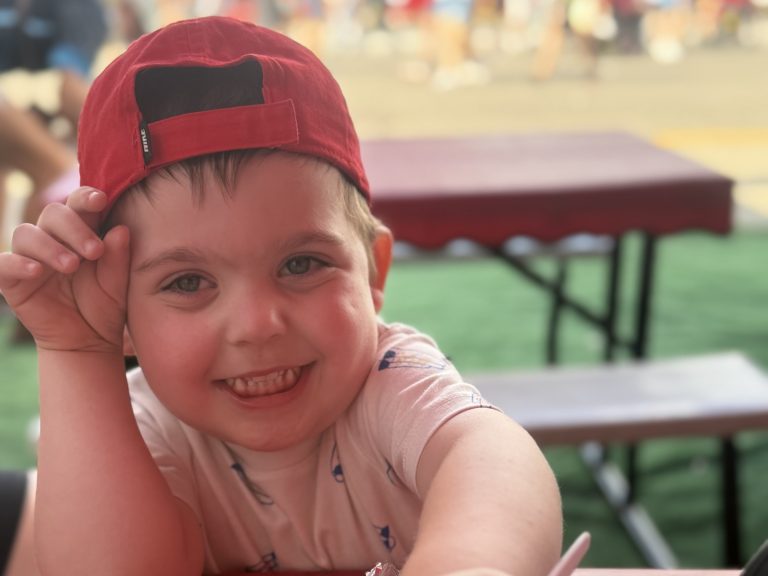 William wearing a red hat and smiling after getting a heart transplant.