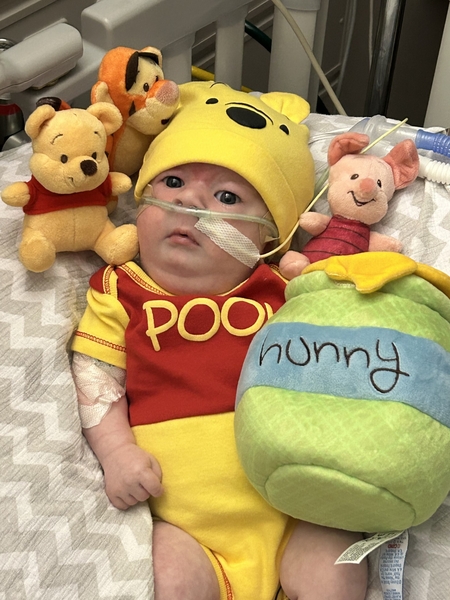 NICU baby dressed up as a Whiny the Poo for Halloween