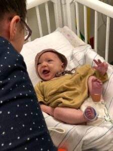 Xenia smiling in hospital bed