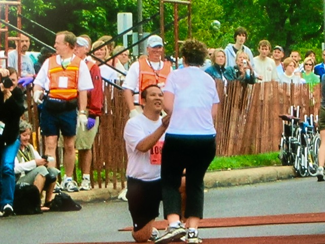 Yung Lu proposing to Natalie Lu at the finish line at the 2005 Twin Cities 10-mile marathon.