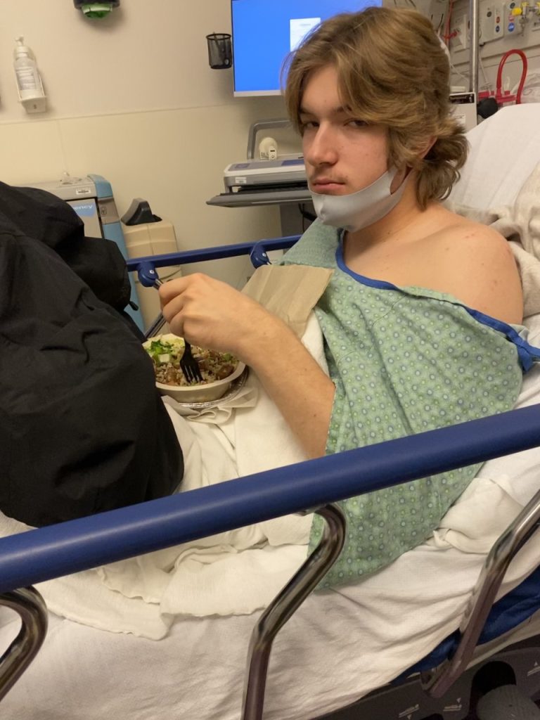 Zander in the hospital eating a meal in bed