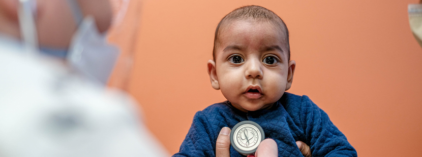 Baby getting an exam with stethoscope